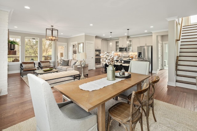 dining room with ornamental molding, dark hardwood / wood-style floors, and a notable chandelier