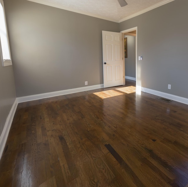 spare room featuring ceiling fan, ornamental molding, and dark hardwood / wood-style floors