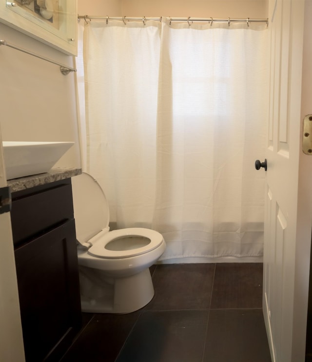 bathroom with tile patterned flooring, vanity, and toilet