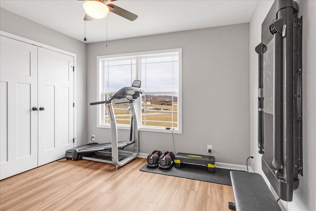 workout area with ceiling fan, plenty of natural light, and light hardwood / wood-style floors