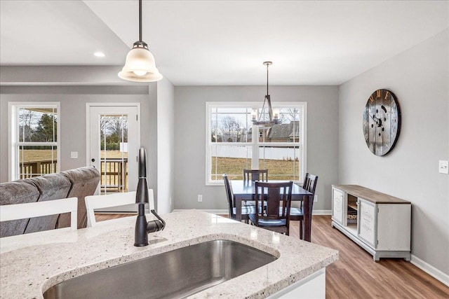 kitchen featuring a healthy amount of sunlight, decorative light fixtures, and sink