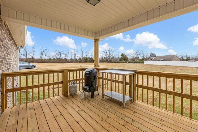 wooden deck with a lawn