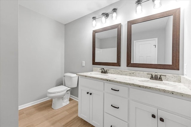 bathroom featuring vanity, toilet, and hardwood / wood-style floors