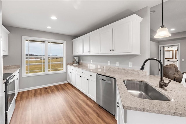 kitchen with pendant lighting, sink, white cabinetry, and stainless steel appliances