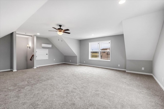 bonus room featuring ceiling fan, lofted ceiling, a wall mounted air conditioner, and carpet floors