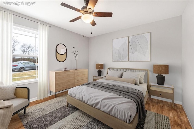 bedroom with hardwood / wood-style floors and ceiling fan