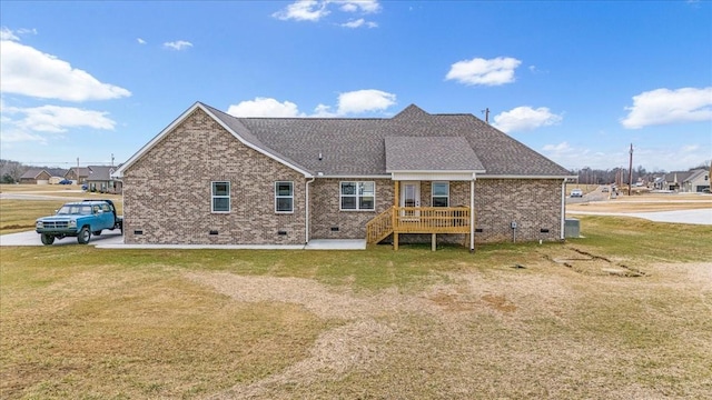 rear view of property featuring a wooden deck and a yard