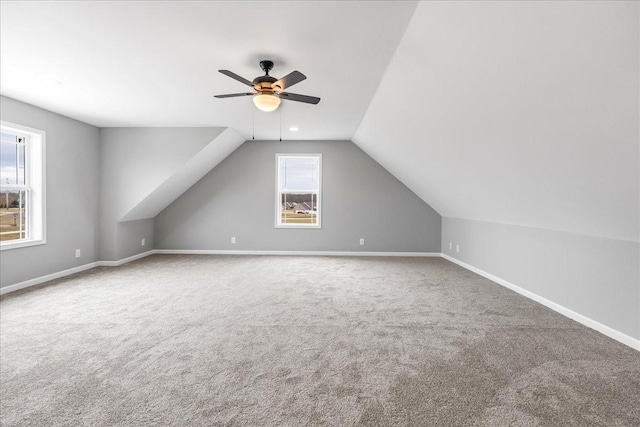 bonus room featuring lofted ceiling, carpet floors, and ceiling fan