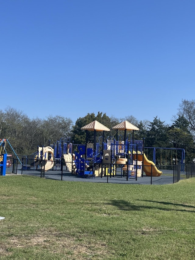 view of jungle gym with a lawn