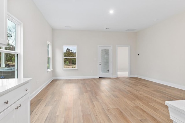 unfurnished living room with light wood-type flooring