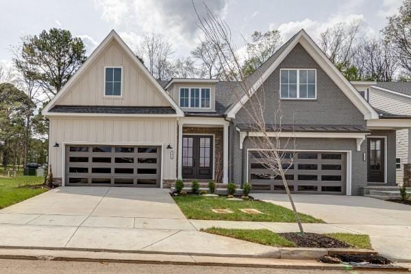 craftsman house with a garage and french doors