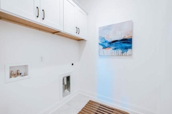 clothes washing area featuring electric dryer hookup, hookup for a washing machine, and cabinets