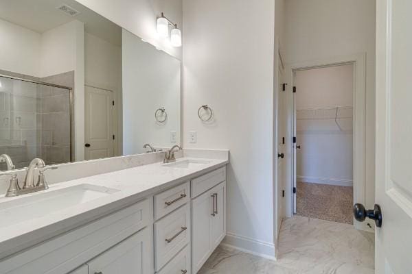 bathroom with vanity and a shower with shower door