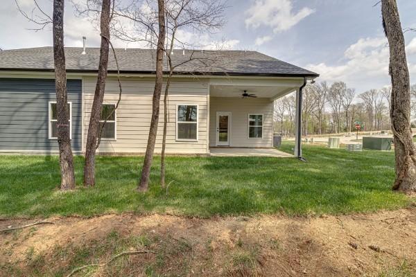 back of house with a patio, ceiling fan, and a lawn