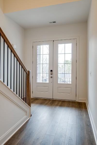 entryway with french doors and dark wood-type flooring