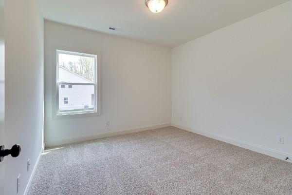 empty room featuring light carpet