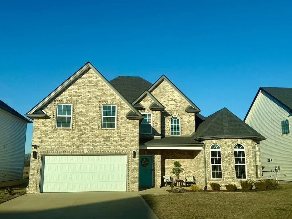 view of front of home with a garage and a front lawn