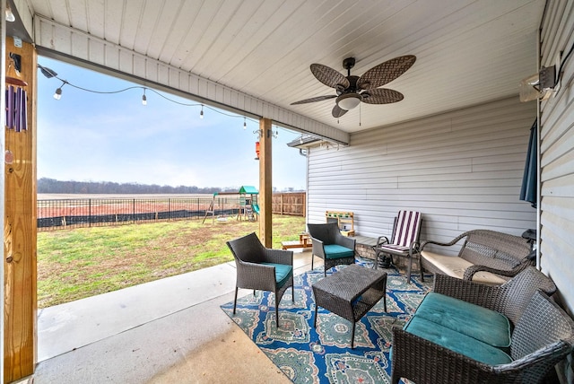 view of patio with a playground, an outdoor hangout area, a rural view, and ceiling fan