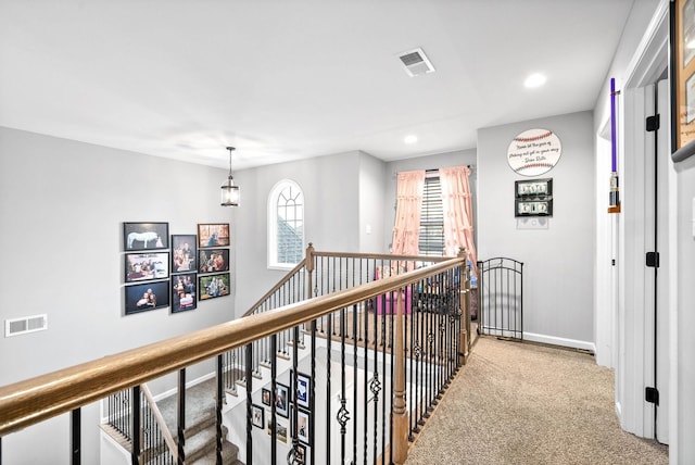 hall featuring carpet flooring