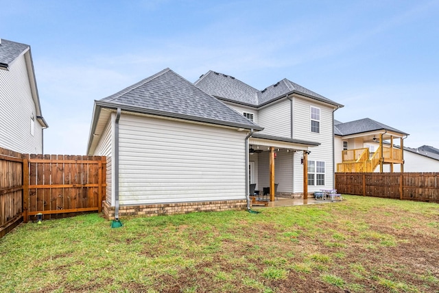 back of house with a yard, ceiling fan, and a patio area