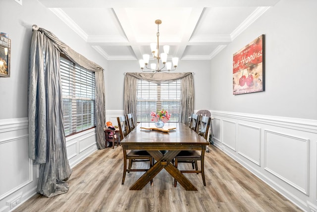 dining space featuring beamed ceiling, coffered ceiling, light hardwood / wood-style floors, and a notable chandelier