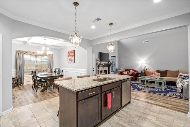 kitchen featuring dark brown cabinetry, light stone counters, crown molding, hanging light fixtures, and dishwasher