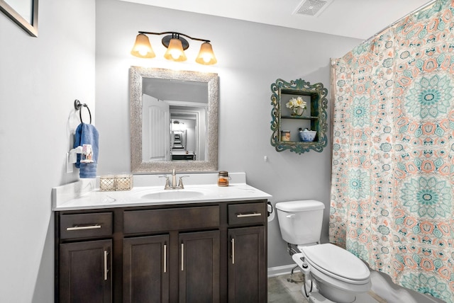 full bathroom with vanity, shower / tub combo, and toilet