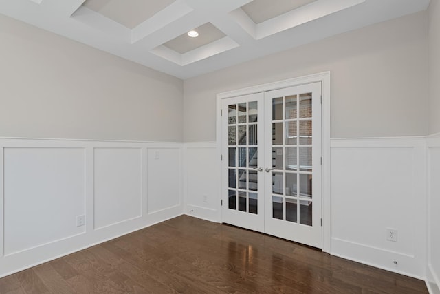 unfurnished room featuring coffered ceiling, dark wood-type flooring, french doors, and beamed ceiling