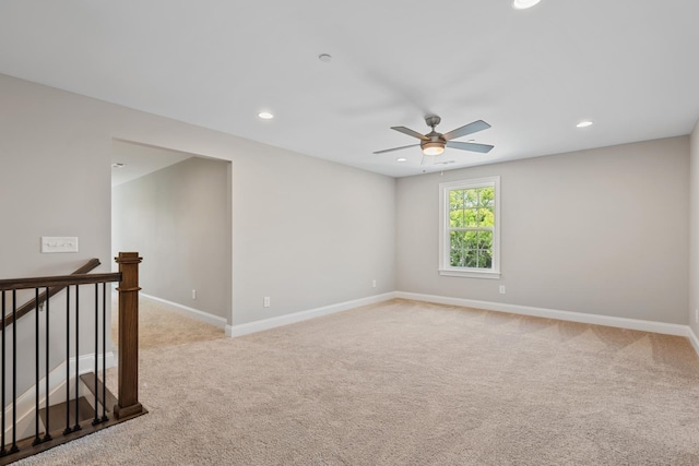 carpeted empty room featuring ceiling fan