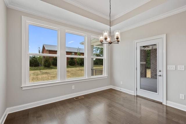 unfurnished dining area featuring crown molding, a chandelier, and dark hardwood / wood-style flooring