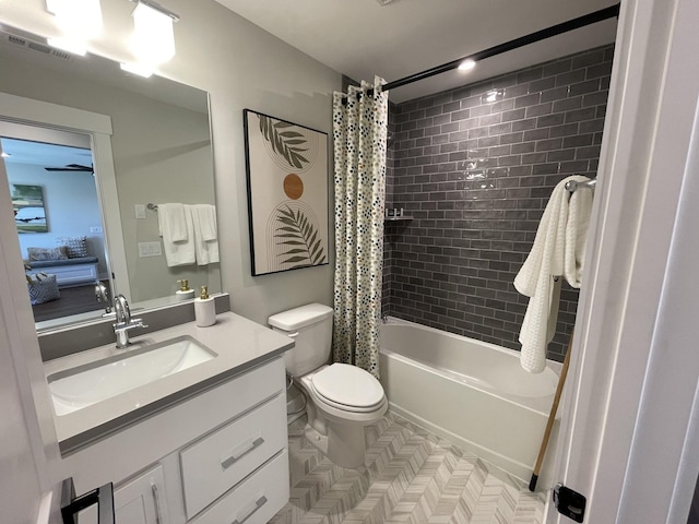 full bathroom with shower / tub combo with curtain, vanity, and toilet