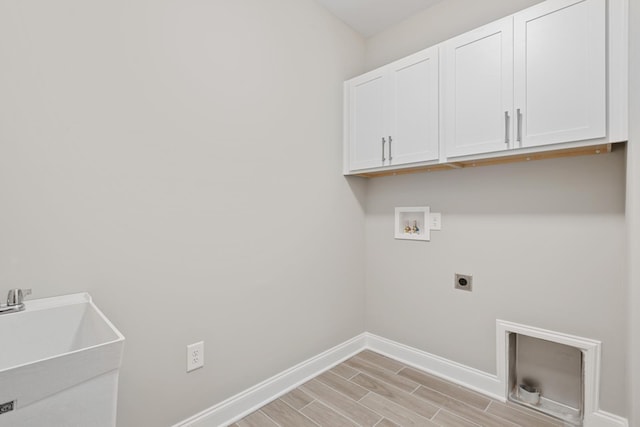 laundry room featuring cabinets, electric dryer hookup, hookup for a washing machine, and sink