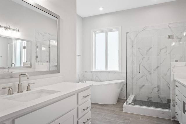 bathroom with vanity and separate shower and tub