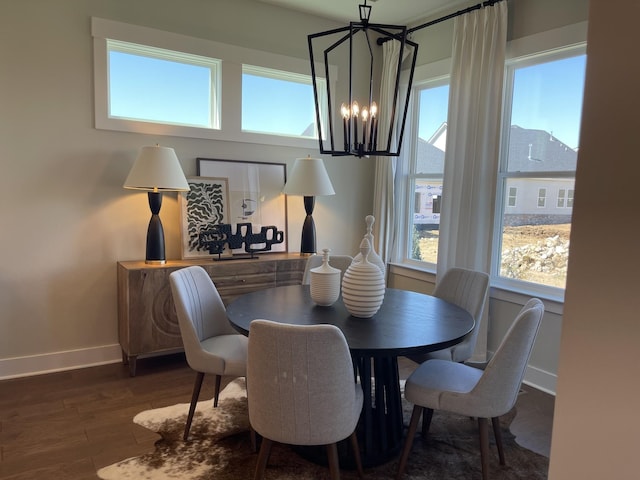 dining area featuring an inviting chandelier and dark wood-type flooring