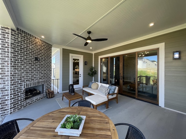 view of patio featuring an outdoor living space with a fireplace and ceiling fan