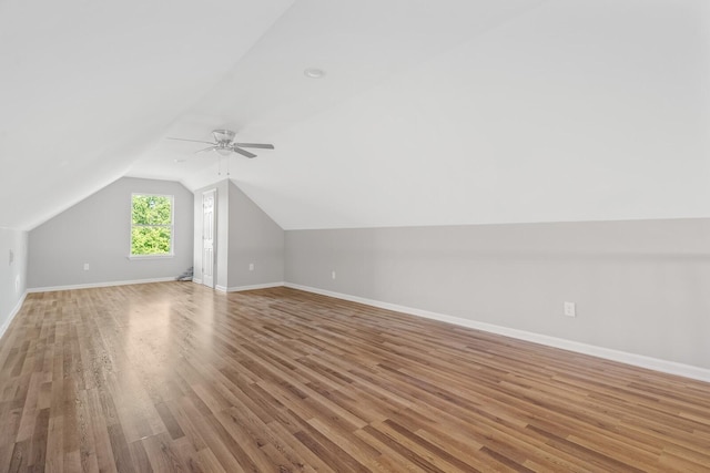 bonus room with lofted ceiling, ceiling fan, and light wood-type flooring