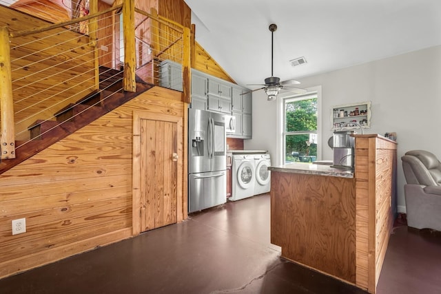 kitchen with lofted ceiling, washer and dryer, ceiling fan, and stainless steel fridge with ice dispenser