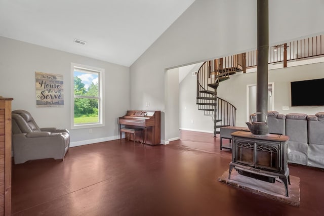 interior space featuring high vaulted ceiling and a wood stove