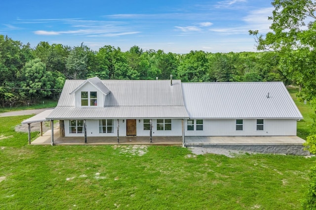 back of property with a yard and a patio area