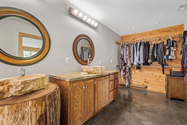 bathroom featuring vanity and concrete flooring