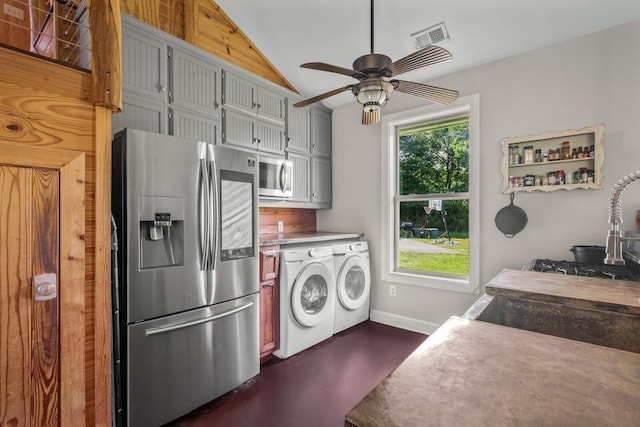 clothes washing area with ceiling fan, a wealth of natural light, and independent washer and dryer