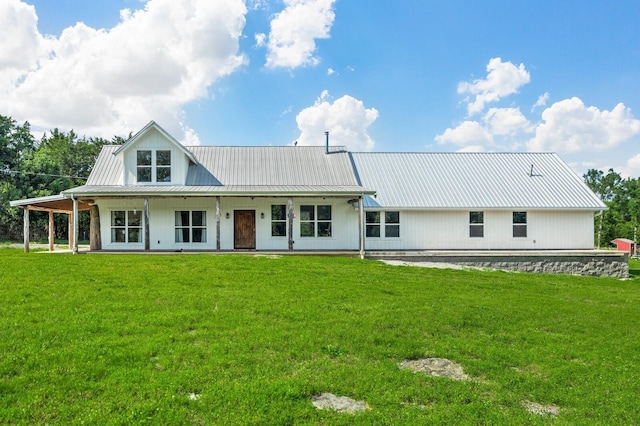 rear view of property with a lawn