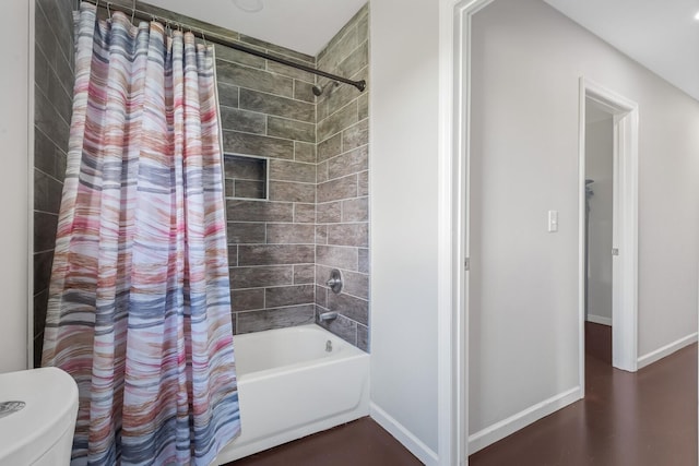 bathroom featuring shower / tub combo and toilet