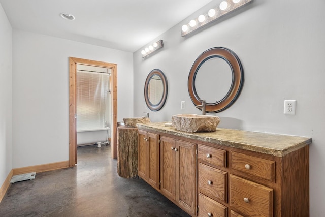 bathroom with vanity and concrete floors