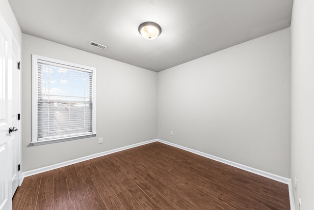 unfurnished room featuring dark hardwood / wood-style flooring