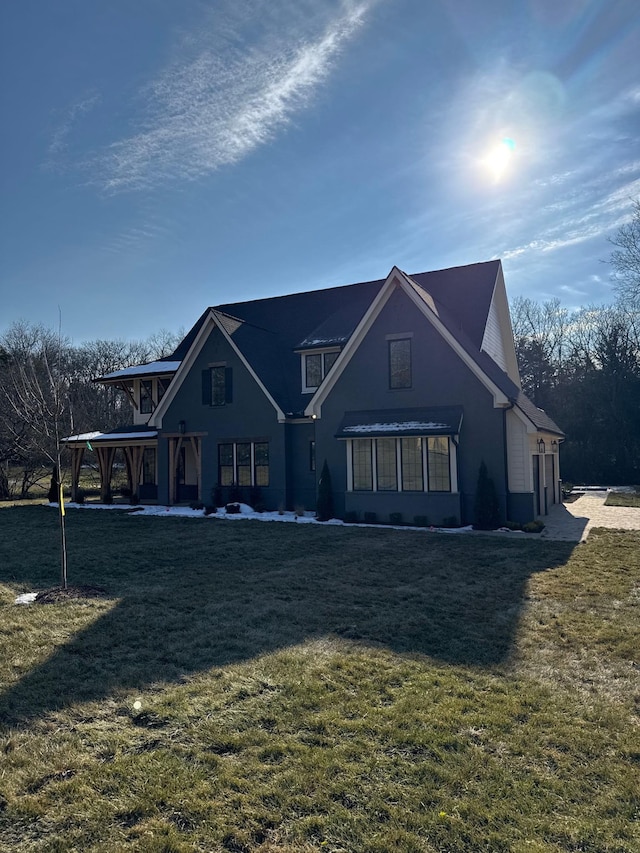 rear view of house featuring a lawn