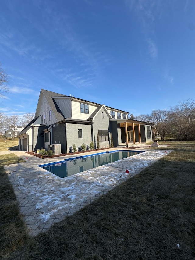 back of property with central AC and a garage