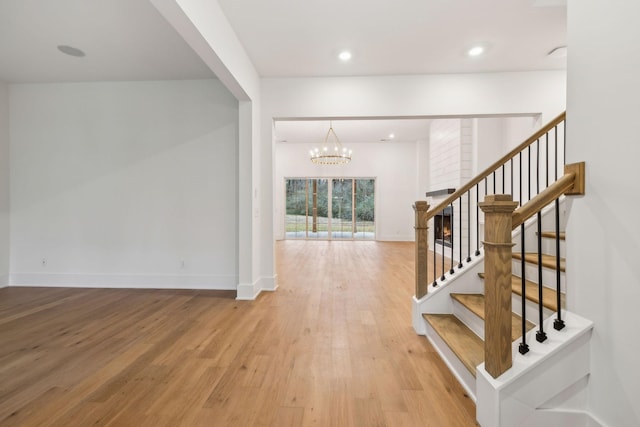 interior space with a notable chandelier and hardwood / wood-style flooring