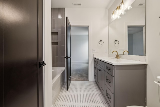 bathroom featuring vanity and a bath