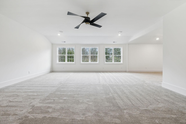 unfurnished room with light carpet, a wealth of natural light, and ceiling fan